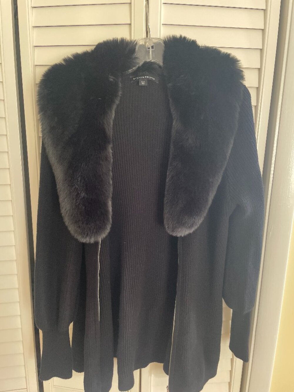100% cotton black coat, with faux fur collar.